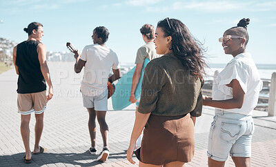 Buy stock photo Diversity, walk and friends on beach promenade while on summer vacation or weekend trip together. Friendship, multiracial and group of people people walking, bonding and talking by ocean on holiday.