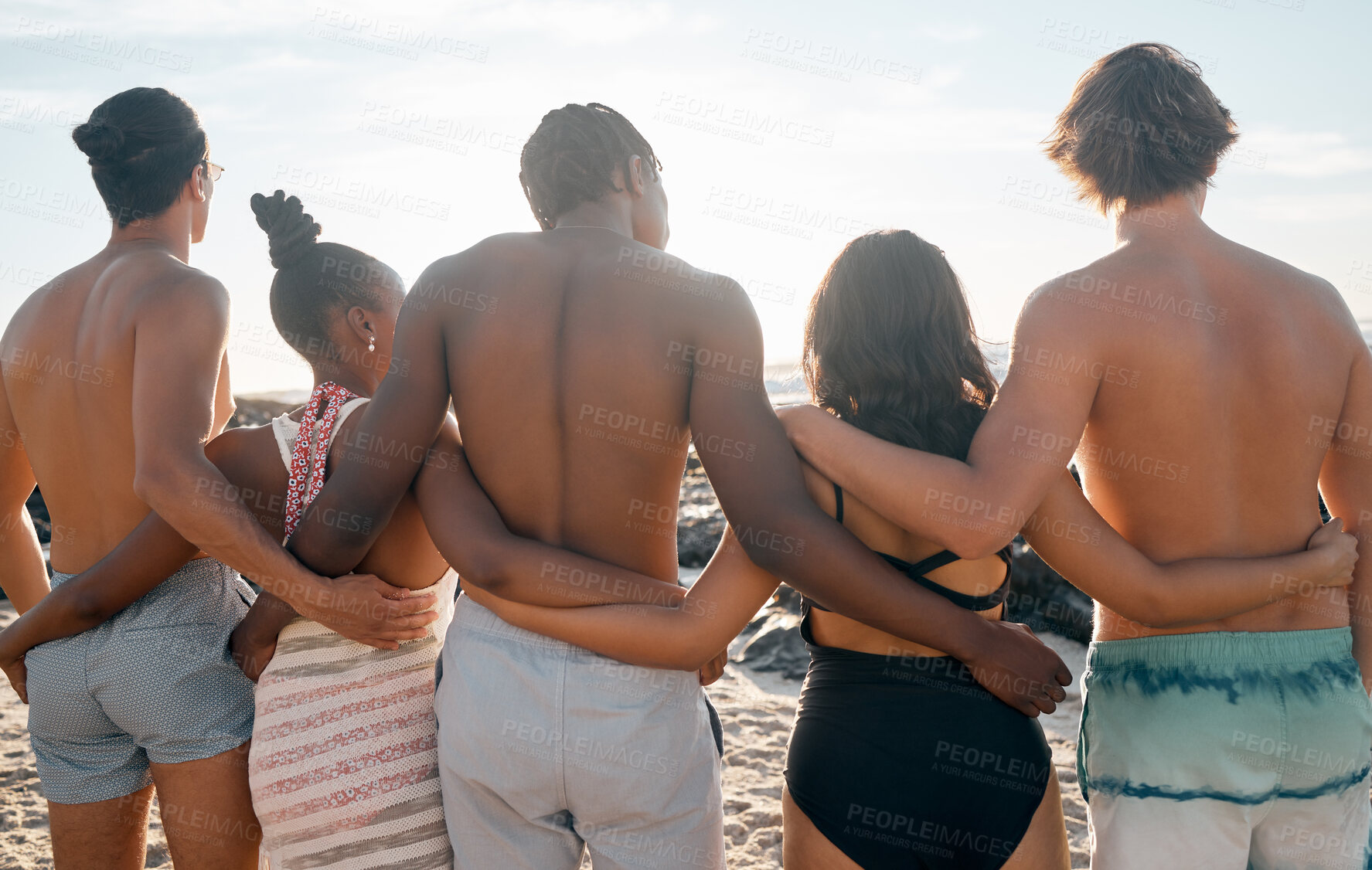 Buy stock photo Friends, back or standing embrace by beach, ocean or sea in social gathering, group vacation or relax summer holiday. Men, women or diversity people in hug, travel bonding or nature community support