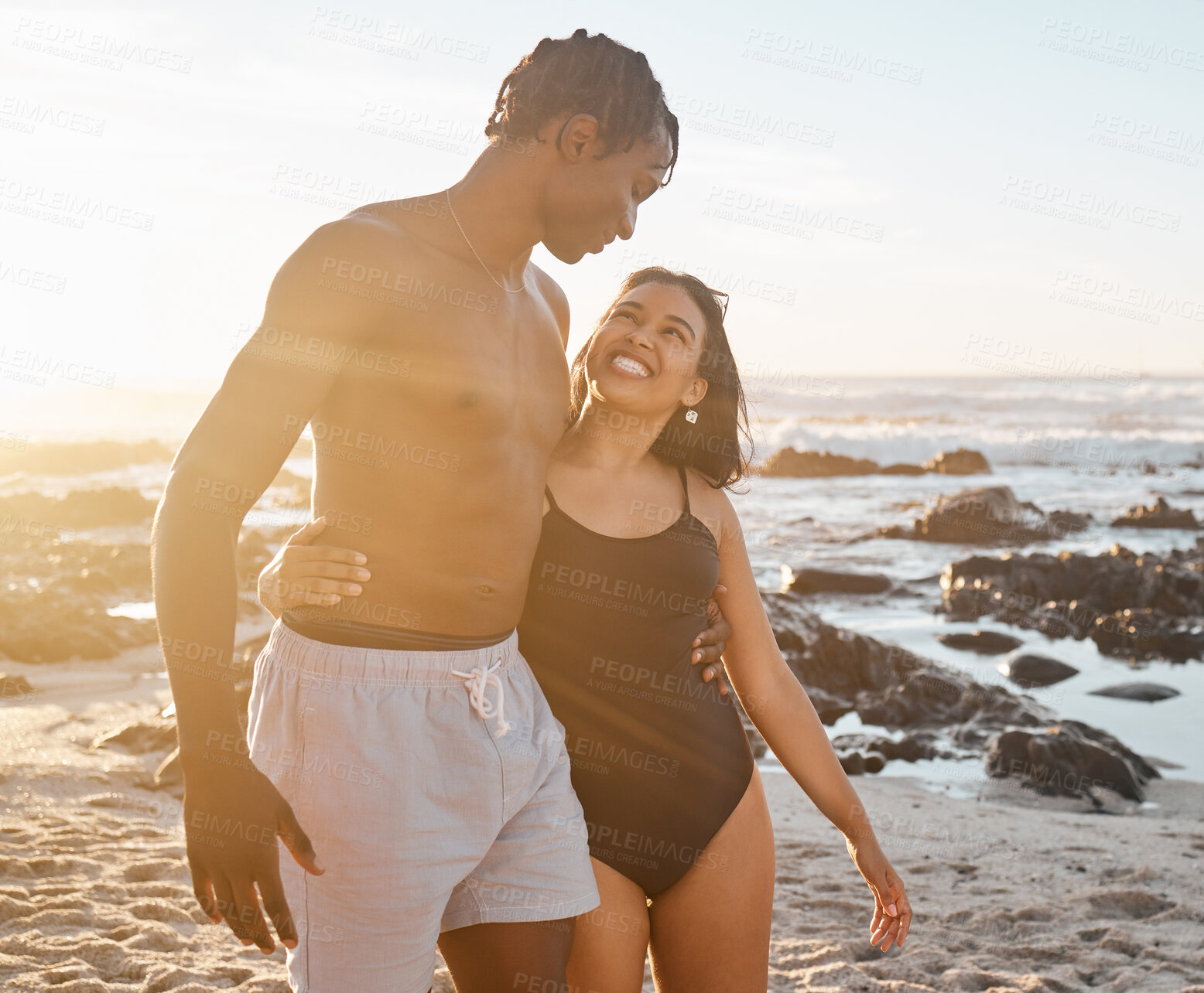 Buy stock photo Happy couple, bonding or swimsuit hug on sunset beach in relax romance holiday, love vacation date or summer location. Smile, black woman or man in swimwear embrace, freedom trust or travel support