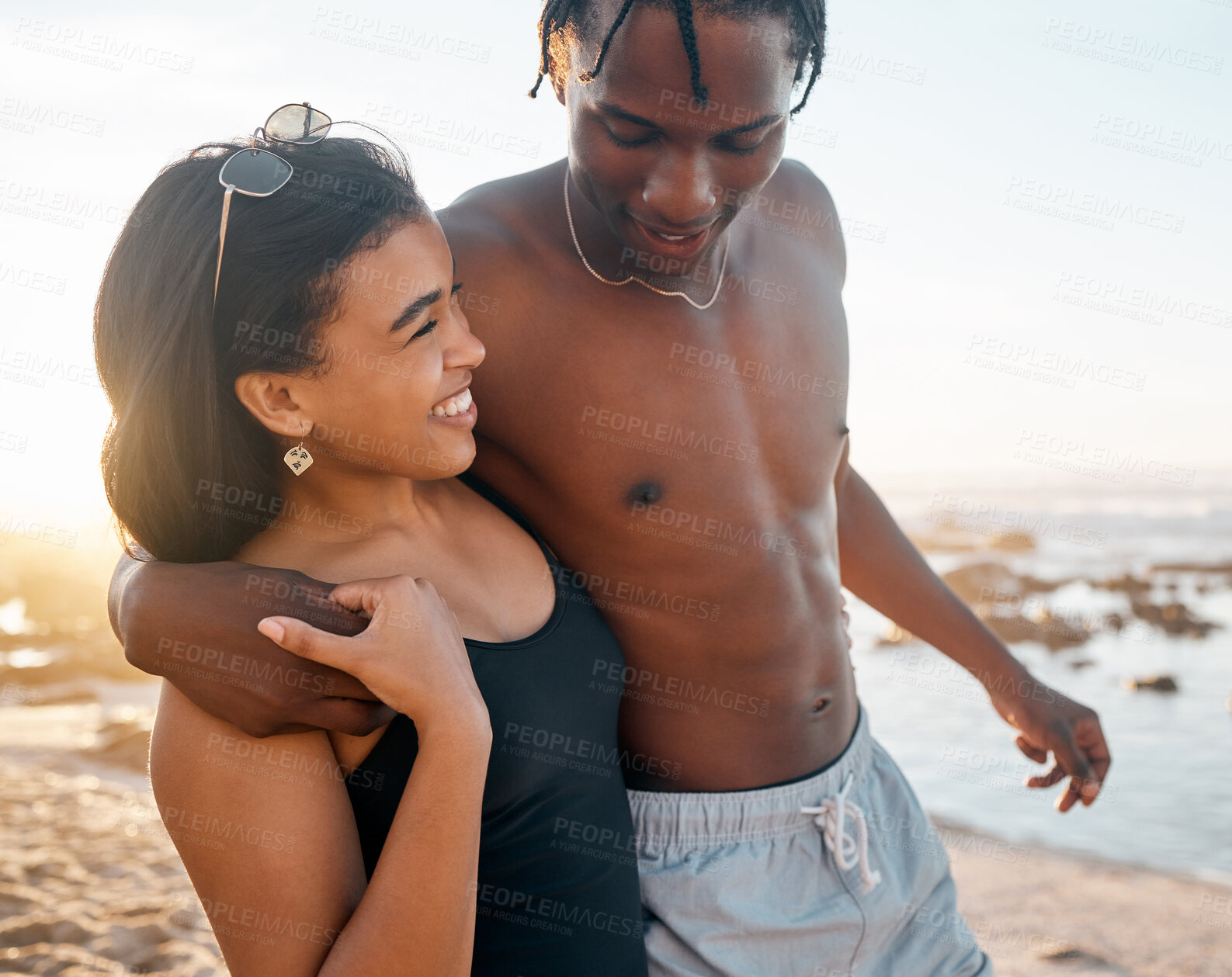 Buy stock photo Couple, happy or swimsuit hug on sunset beach in relax romance holiday, love vacation date or bonding summer location. Smile, black woman or man in swimwear embrace, freedom trust or travel support