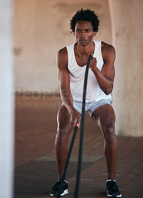 Exercise, fitness and black man with battle ropes for training workout in the city outdoors. Sports, energy and male body builder or athlete with heavy rope for strength, power or health in street.