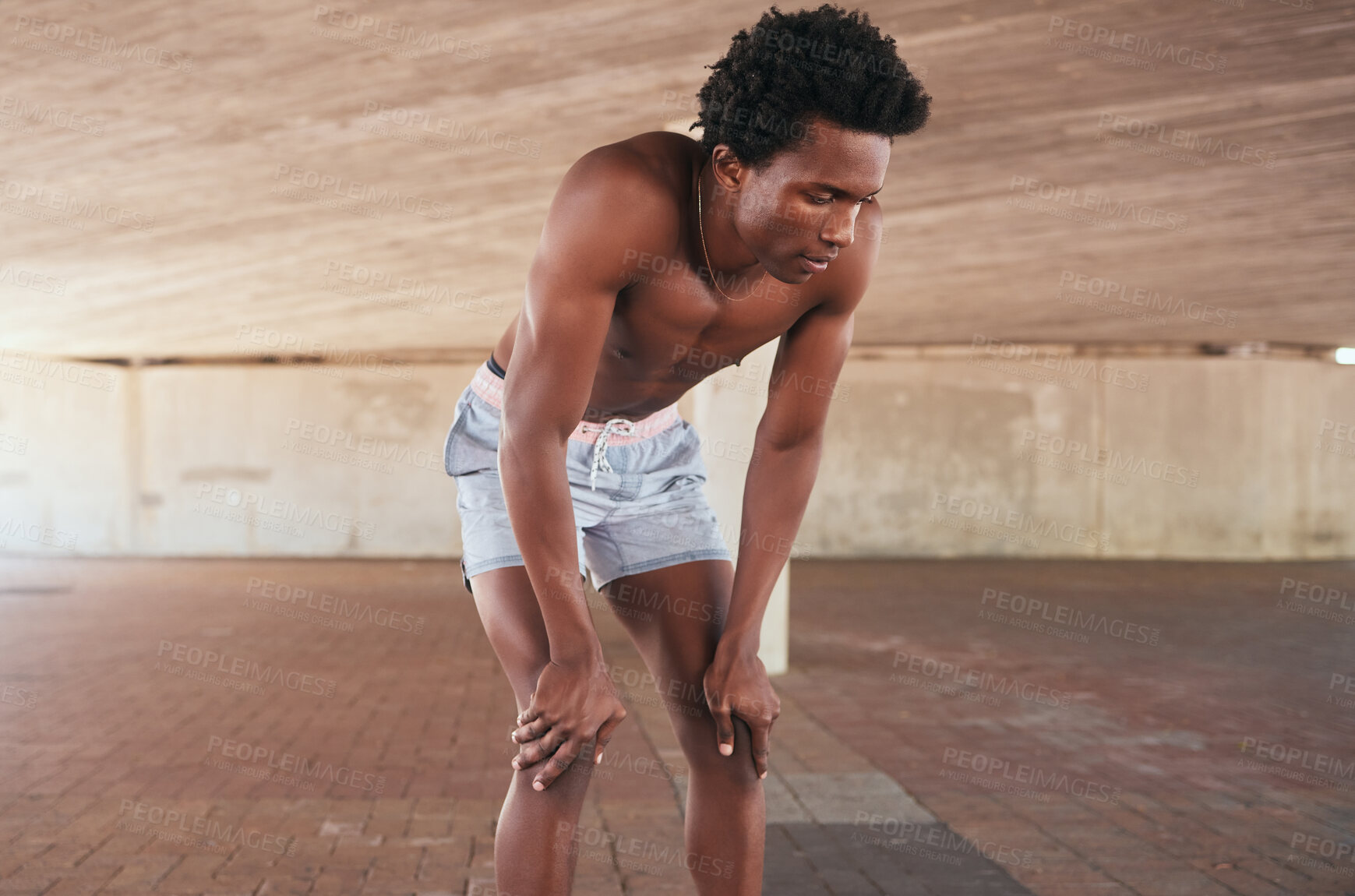 Buy stock photo Fitness, break and tired man runner in a city, breathe and rest after cardio workout outdoor. Guy, stop and breathing after running, exercise and training for health, endurance or performance in town