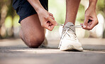 Park, shoelaces and ground with man hands, outdoor adventure and training for wellness in summer. Shoes, sneakers and start morning for fitness, exercise and strong body development in nature park