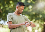 Fitness, time and man with watch in nature to check heart, running progress and notification. Sport, exercise and athlete runner reading health, pulse or tracking training on technology in Australia