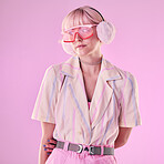 Fashion, glasses and woman on pink background for beauty, vaporwave style and cosmetics in studio. Creative aesthetic, makeup and female model with earmuffs, trendy clothes and cyberpunk accessories