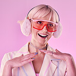 Fashion, glasses and woman with smile on pink background for beauty, vaporwave style and cosmetics. Creative aesthetic, makeup and face of girl with earmuffs, trendy clothes and cyberpunk accessory