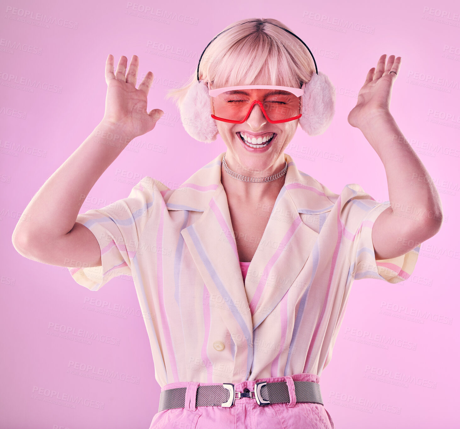 Buy stock photo Fashion, beauty and happy woman isolated on pink background excited, wow and dancing on creative aesthetic. Earmuffs, clothes and cool, retro and punk sunglasses of gen z model or person in studio