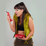 Wow, anger and woman on a telephone call isolated on a grey studio background. Fashion, communication and surprised girl holding a landline phone for conversation, talking and bad news on a backdrop