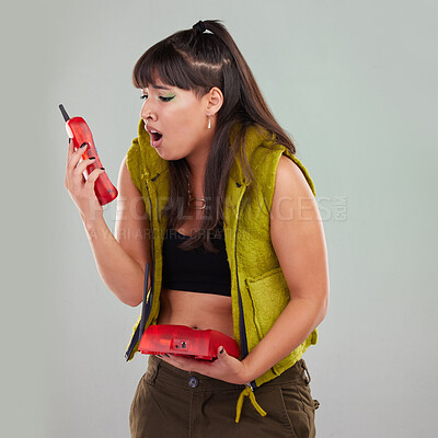 Buy stock photo Wow, anger and woman on a telephone call isolated on a grey studio background. Fashion, communication and surprised girl holding a landline phone for conversation, talking and bad news on a backdrop