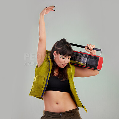 Buy stock photo Dance, trendy and woman with a radio for music isolated on a grey studio background. Party, fashion and dancing girl holding a cassette stereo listening to audio, boombox record and track with rhythm