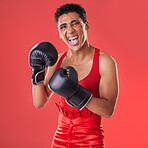 Boxing, gloves and portrait of a gay man excited for a fight isolated on a red background in studio. Fitness, happy and lgbt person ready for a fighting competition, game and sport on a backdrop