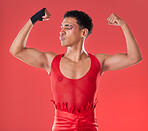 LGBTQ, flexing and empowerment of gay man or nonbinary person with fashion isolated in studio red background. Strength, queer and model with style and beauty in the LGBT community pride