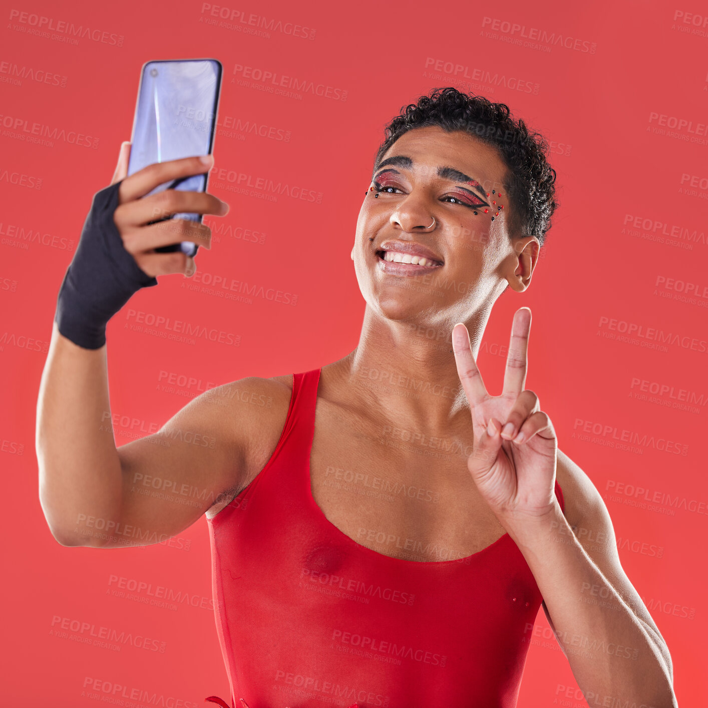Buy stock photo Selfie, queer and gay man peace sign gesture for social media update isolated against a studio red background. LGBTQ, non binary and gen z fashion model with online photo for the internet