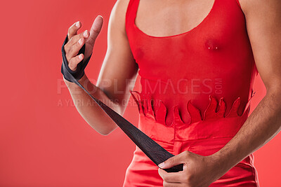 Buy stock photo Young man and boxing wrap isolated on red background for queer fight, punk fashion and lgbtq aesthetic. Bodybuilder, self defense and model, sports person or boxer hands with fitness or martial arts