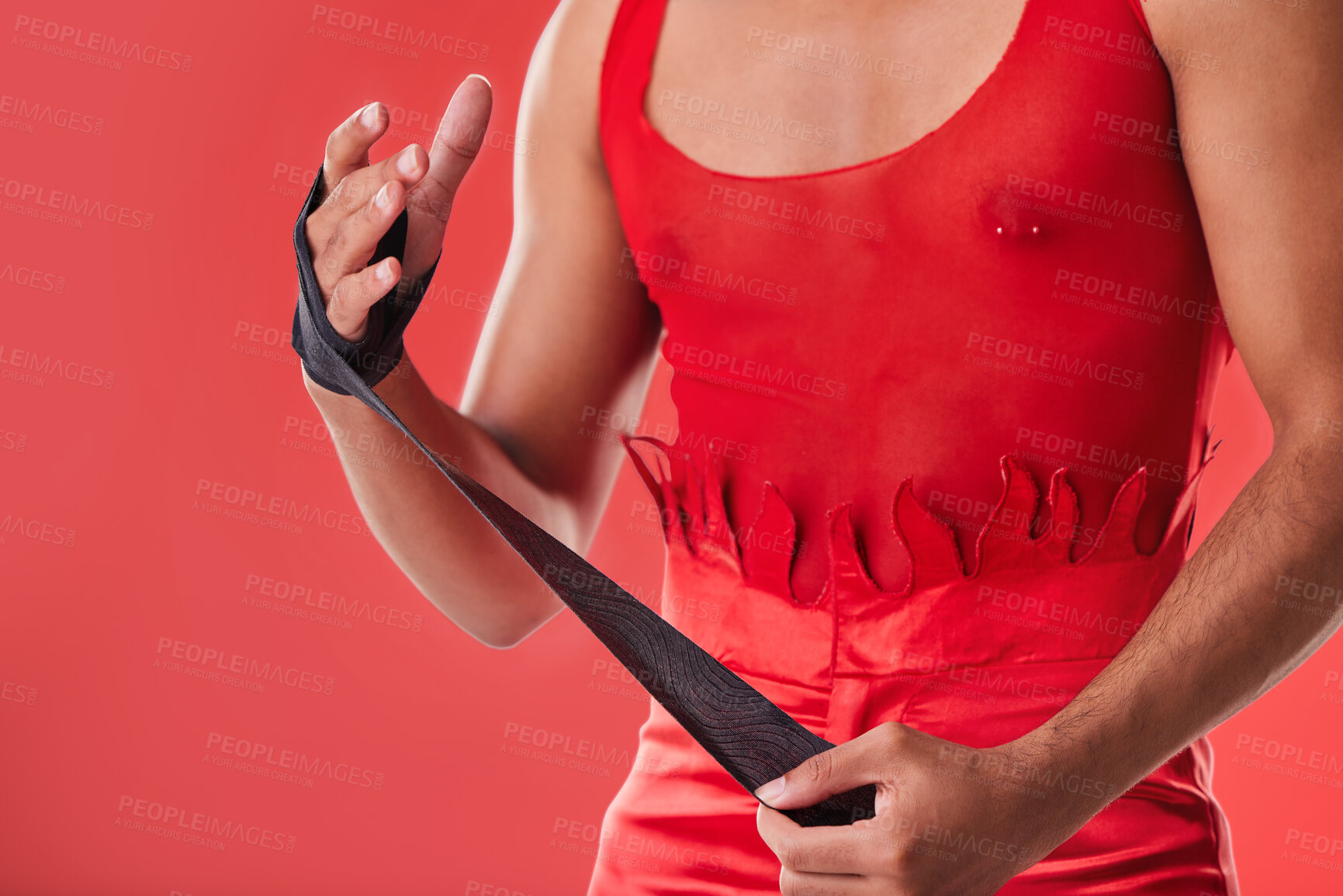 Buy stock photo Young man and boxing wrap isolated on red background for queer fight, punk fashion and lgbtq aesthetic. Bodybuilder, self defense and model, sports person or boxer hands with fitness or martial arts