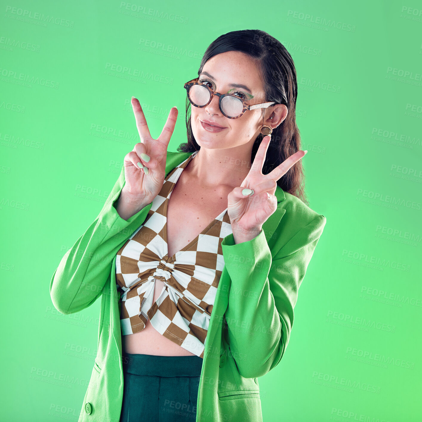 Buy stock photo Peace, fashion and portrait of a woman with a sign isolated on a green background in a studio. Happy, cool and carefree teacher showing an emoji hand with fashionable, elegant and classy style