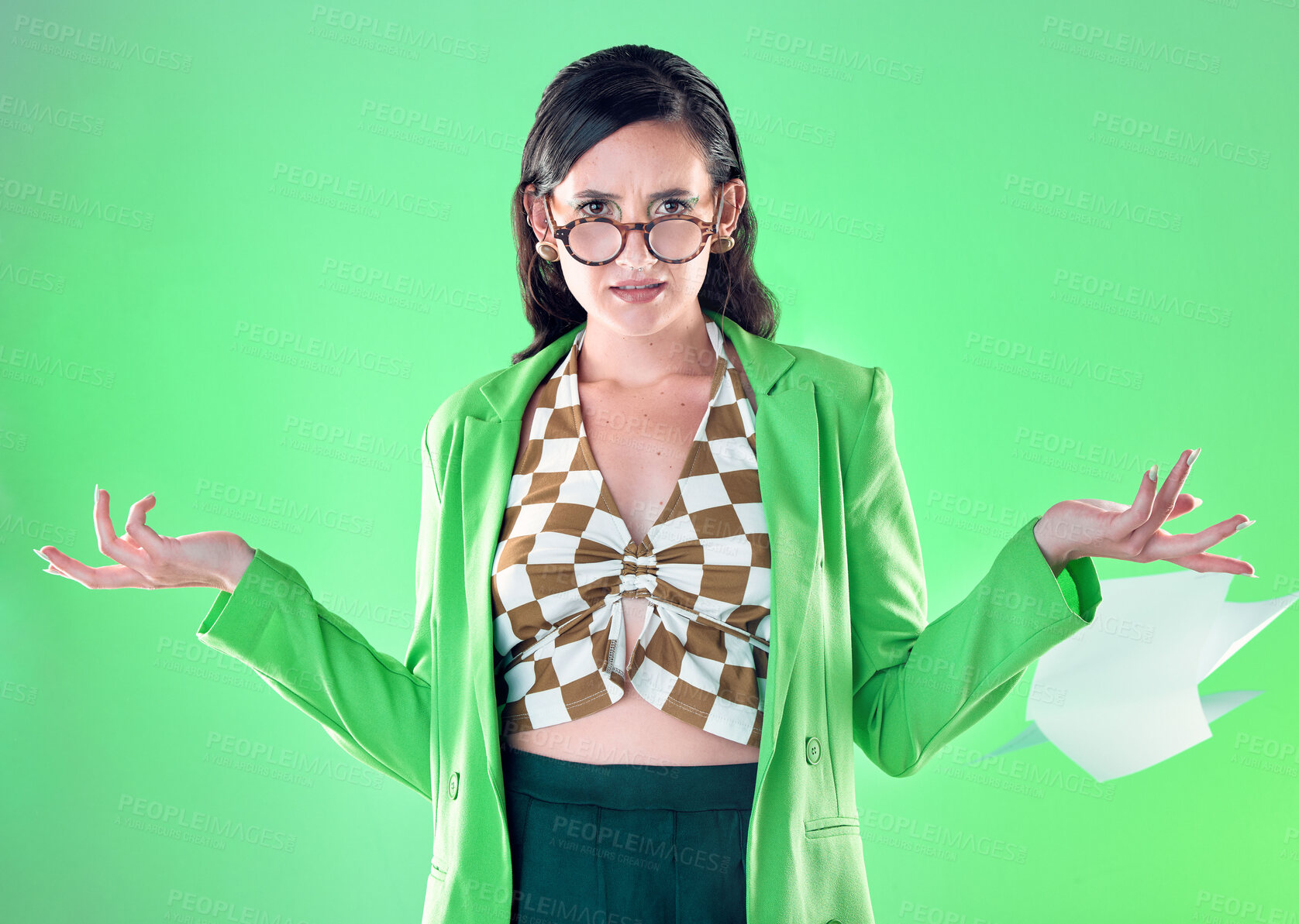 Buy stock photo Confused, anger and portrait of a teacher with paper isolated on a green background in a studio. Anxiety, tired and trendy woman with edgy and fashionable style throwing paperwork while frustrated