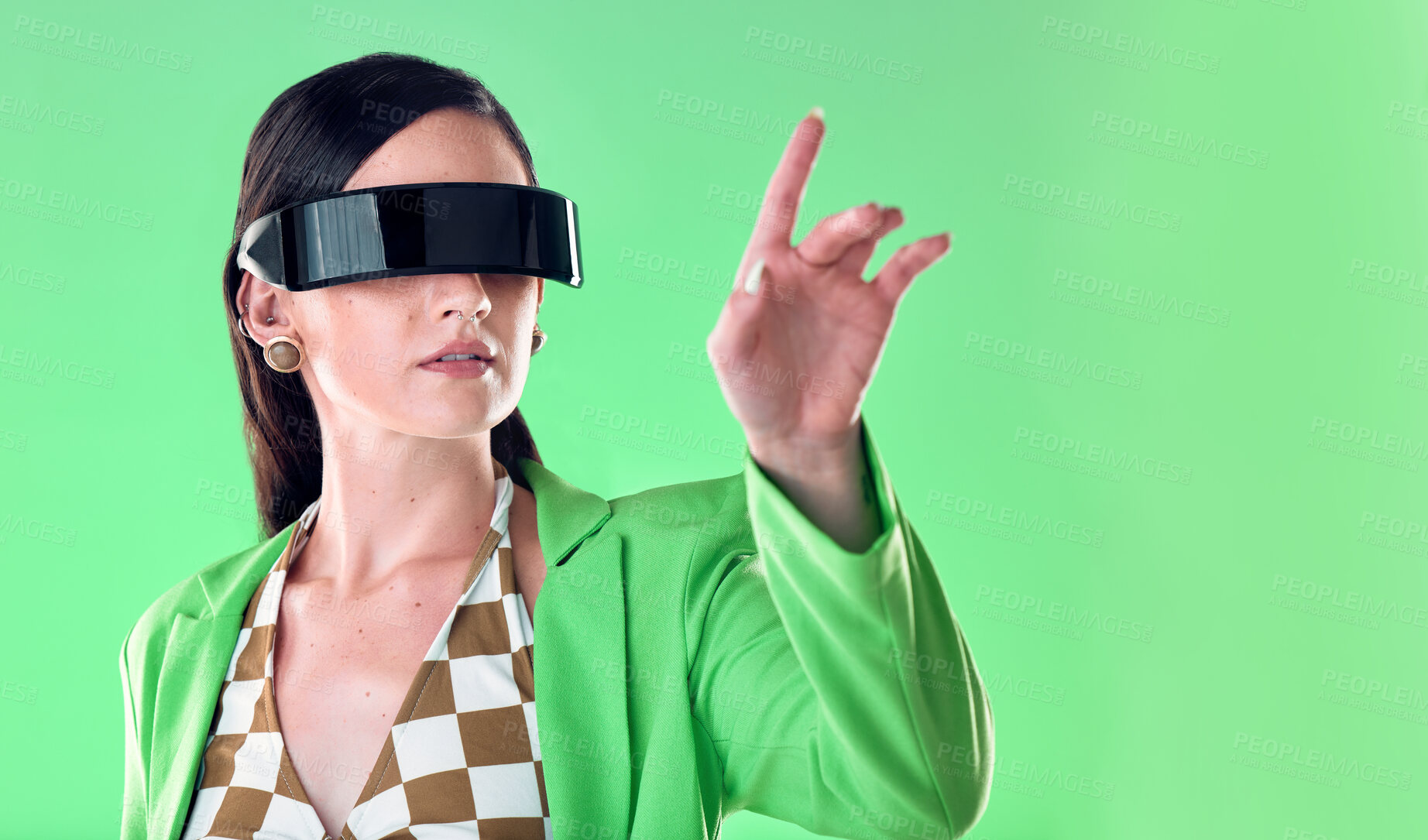 Buy stock photo Woman, virtual reality and glasses in studio with hand by green backdrop, background and gaming online. Young model, aesthetic and ideas with vr, esport and fashion with analytics, ux and metaverse