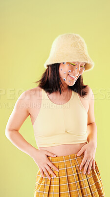 Buy stock photo Fashion, carefree and an Asian woman with eyes for playing isolated on a yellow background in a studio. Smile, comic and stylish girl with a funny product for playful expression on a backdrop