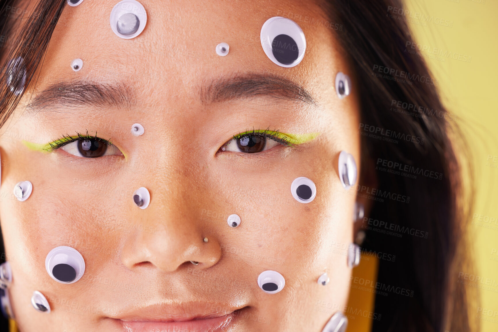 Buy stock photo Gen z, eyes sticker art and portrait of an Asian woman with makeup and colorful cosmetics. Creative googly eye application, style influencer and cosmetic creativity of a model with studio background