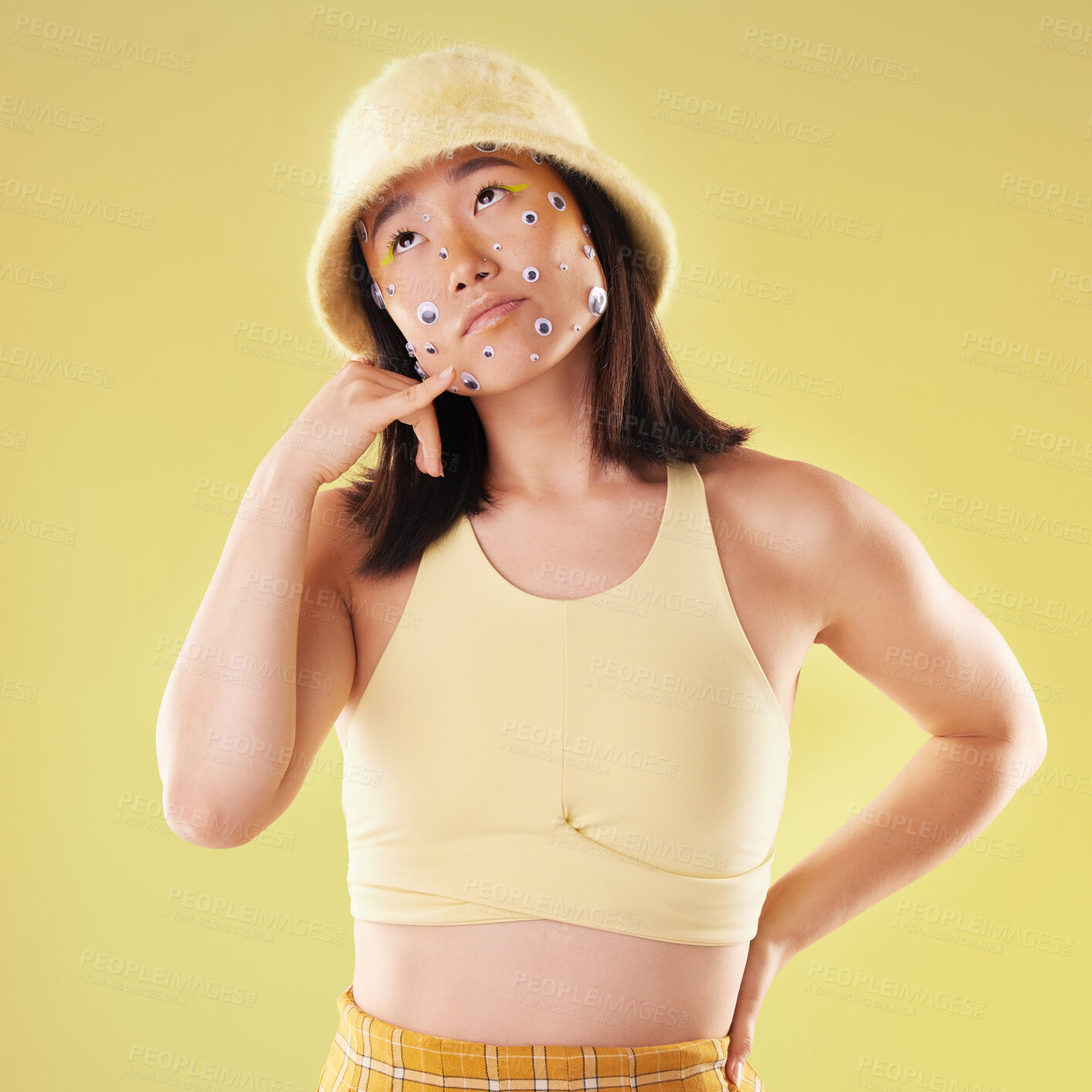 Buy stock photo Eyes, thinking and woman with a hand call isolated on a yellow background in a studio. Idea, fashion and Asian girl with fingers in a telephone gesture for communication, conversation and talking