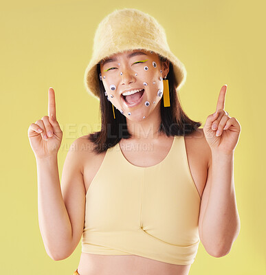 Buy stock photo Portrait, pointing and woman with eyes for comedy isolated on yellow background in a studio. Direction, comic and Asian girl with gesture up and facial product for expression and funny on a backdrop