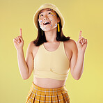 Thinking, pointing and woman with eyes for comedy isolated on a yellow background in a studio. Idea, comic and Asian girl with a gesture up and facial product for expression and funny on a backdrop