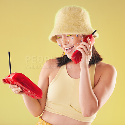 Buy stock photo Woman, landline phone call and studio background for yellow fashion, excited and smile with eyes sticker art on face. Asian gen z model, 90s aesthetic and telephone communication, talk or happy chat