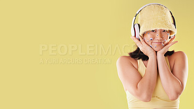 Buy stock photo Fashion, music headphones and woman portrait with mockup space isolated on yellow background. Face of a happy asian girl model with tech for listening to audio, sound or podcast advertising in studio