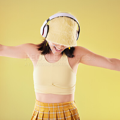 Buy stock photo Music headphones, dance and woman in studio isolated on a yellow background. Eye stickers, freedom technology and happy female model dancing, singing and streaming radio, podcast and audio song.