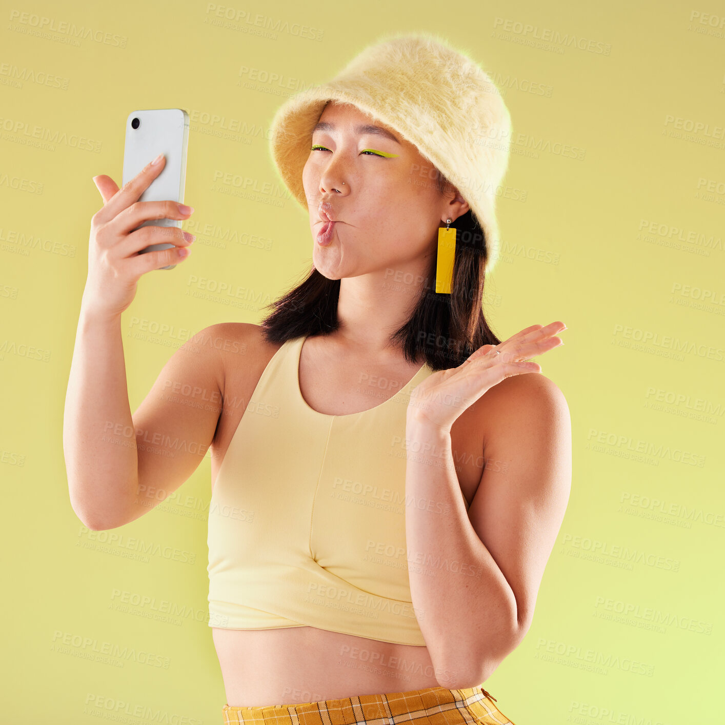 Buy stock photo Selfie, beauty and Asian woman with funny face in studio isolated on yellow background. Comedy, crazy lips and comic female model taking pictures or photo for social media memory and profile picture