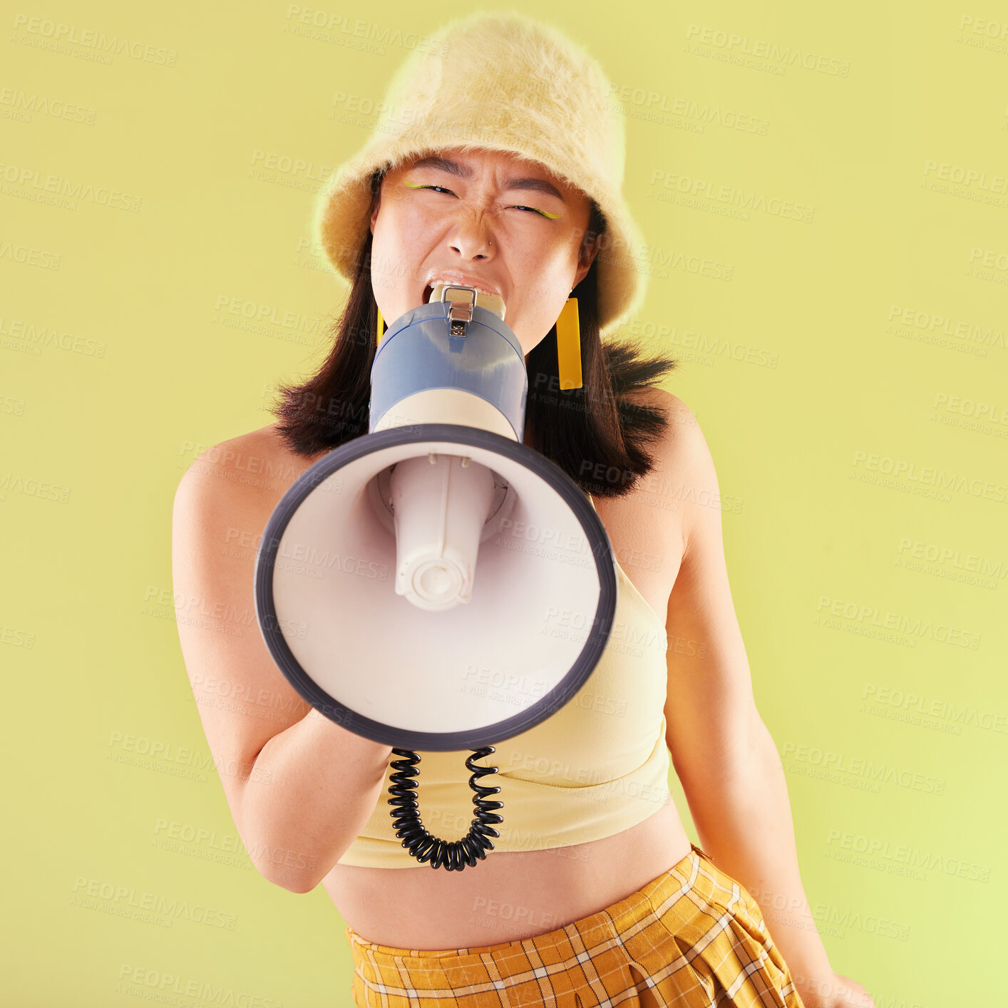 Buy stock photo Asian, woman and studio with megaphone for protest, speech and activism for human rights by background. Young gen z model, loudspeaker broadcast and yellow 90s aesthetic for change, justice and voice