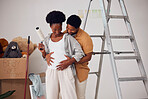 Love, pregnancy or happy couple hugging in home renovation, diy or house remodel together by apartment ladder. African, partnership or black man with pregnant woman excited about baby or family 