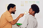 Painting, funny or happy black couple in DIY, home renovation or house remodel together with a paintbrush. Playing, smile or African man laughing with woman working with team work in partnership