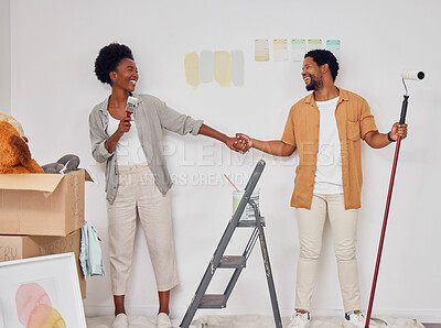 Buy stock photo Painting, holding hands or black couple singing in DIY, home renovation or remodel together with paintbrush. Playing, smile or fun African man laughing with happy woman dancing in house with teamwork