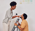 Painting, ladder or funny black couple in DIY, home renovation or house remodel together with paintbrush. Playing, smile or African man laughing with happy woman working with teamwork in partnership