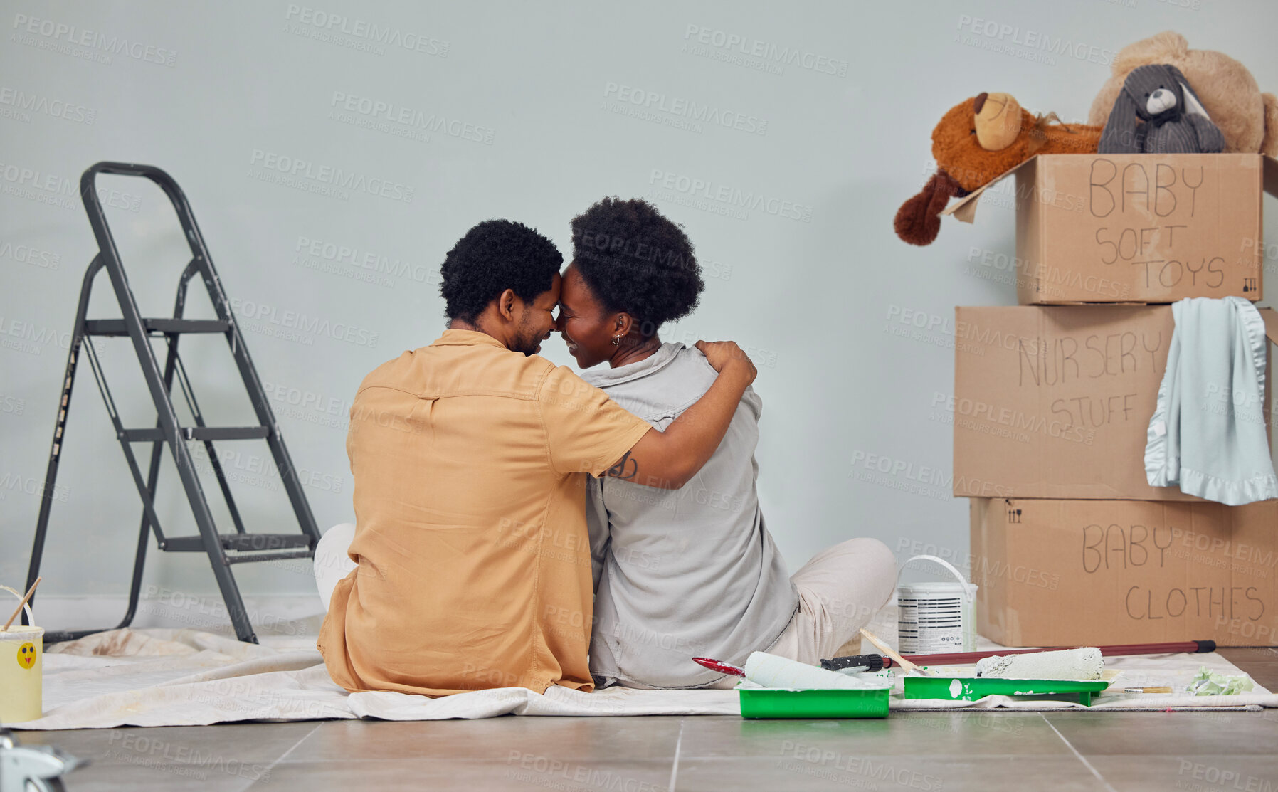 Buy stock photo Forehead, floor or black couple love home renovation, diy or house remodel a wall together. Back view, painting or African man with a happy woman planning or hugging with teamwork in partnership 