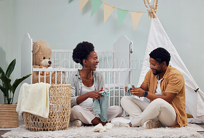 Buy stock photo Pregnant and baby room and black couple happy to prepare for a family home and folding clothes. Man and woman together talking about excited pregnancy future, love and life insurance on bedroom floor