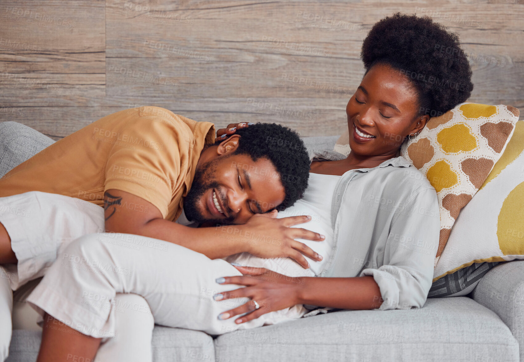 Buy stock photo Pregnant,  black couple and listening to stomach while excited and happy on lounge couch. Man and woman together talking pregnancy future, love and life insurance for healthy lifestyle and heartbeat