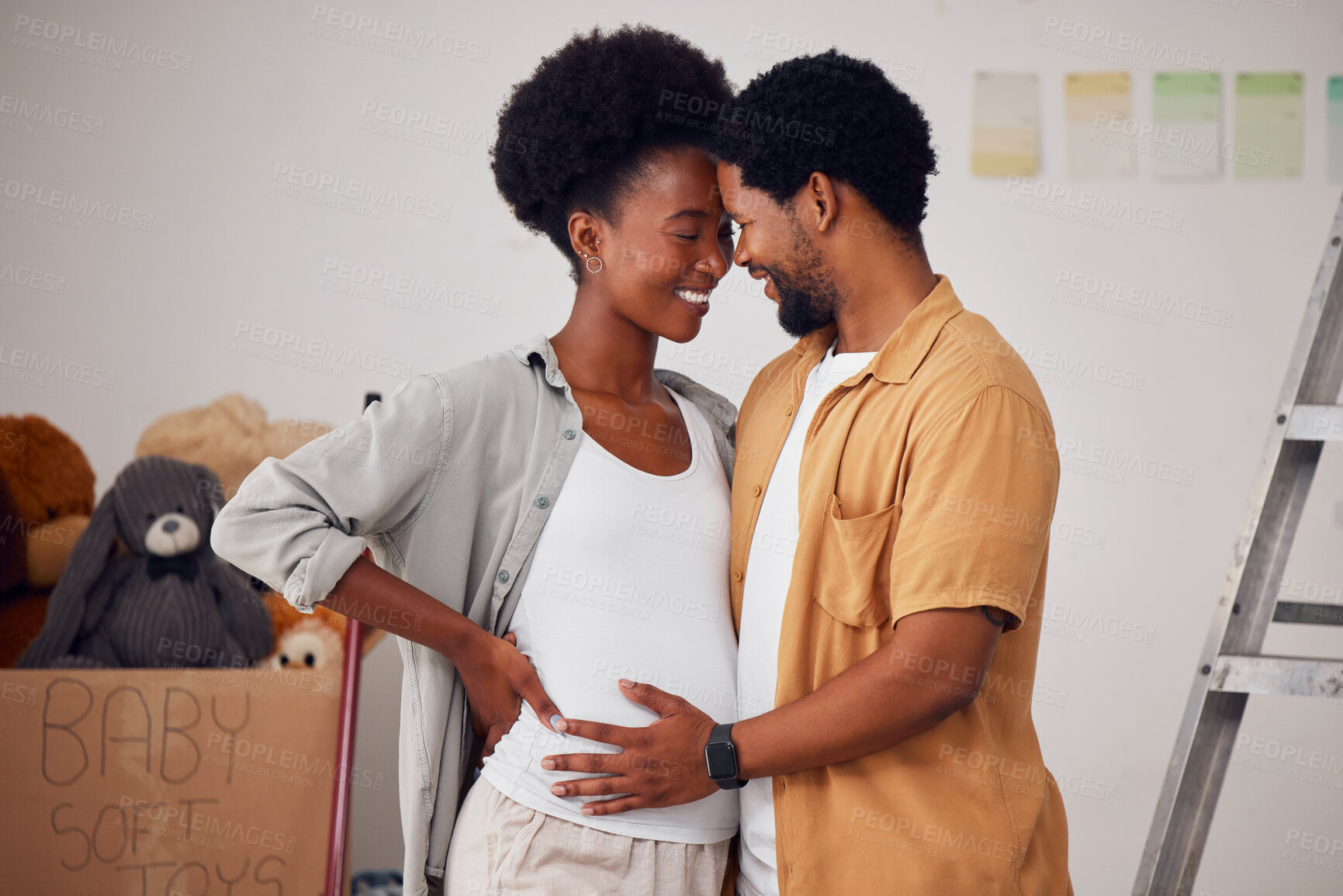 Buy stock photo Love, pregnancy or black couple hug in home renovation, diy or house remodel together by apartment ladder. Forehead, happy smile or African man and pregnant woman excited about baby or new family 