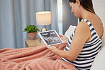 Pregnant, woman and tablet ultrasound scan in home bedroom for development or growth. Person with wifi connection for gynecology telehealth, pregnancy update and health check with sonogram photograph