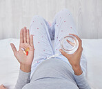 Pills, water and woman hands for pregnancy health, growth and wellness. Pregnant person in home bedroom above glass and Pharma medicine supplement, nutrition and iron or magnesium for development