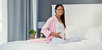 Relax, happy and portrait of a pregnant woman on a bed for peace, rest and touching stomach. Smile, baby and girl feeling her belly during a pregnancy, maternity leave and break in the bedroom