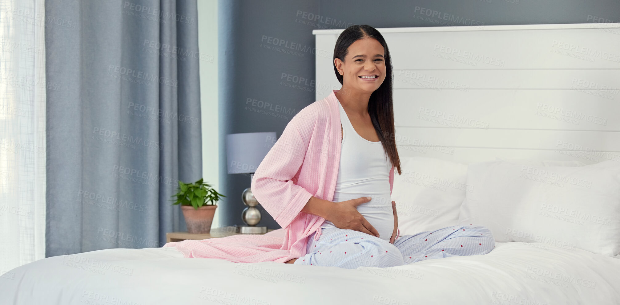 Buy stock photo Relax, happy and portrait of a pregnant woman on a bed for peace, rest and touching stomach. Smile, baby and girl feeling her belly during a pregnancy, maternity leave and break in the bedroom