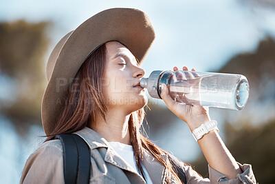 Buy stock photo Hiking, fitness and woman drinking water for outdoor adventure, nature walking with nutrition, health and wellness. Liquid bottle for tired young person on journey, sports and trekking in summer