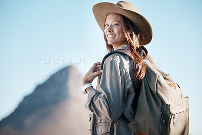 Buy stock photo Hiking woman, portrait and smile by mountain, summer or explore with backpack, excited or happy for workout. Hiker girl, blue sky and travel for freedom, nature vacation and holiday for training goal