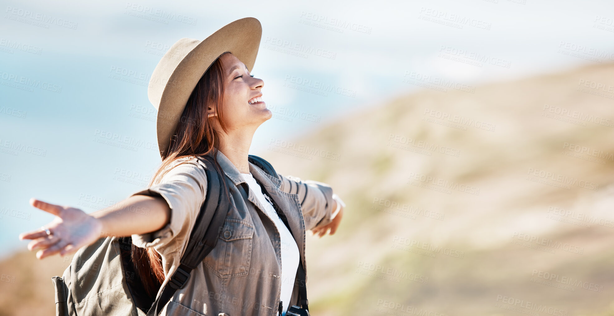 Buy stock photo Woman, tourist and smile for travel freedom, hiking adventure or backpacking journey on mountain in nature. Female hiker smiling with open arms enjoying fresh air, trekking or scenery on mockup