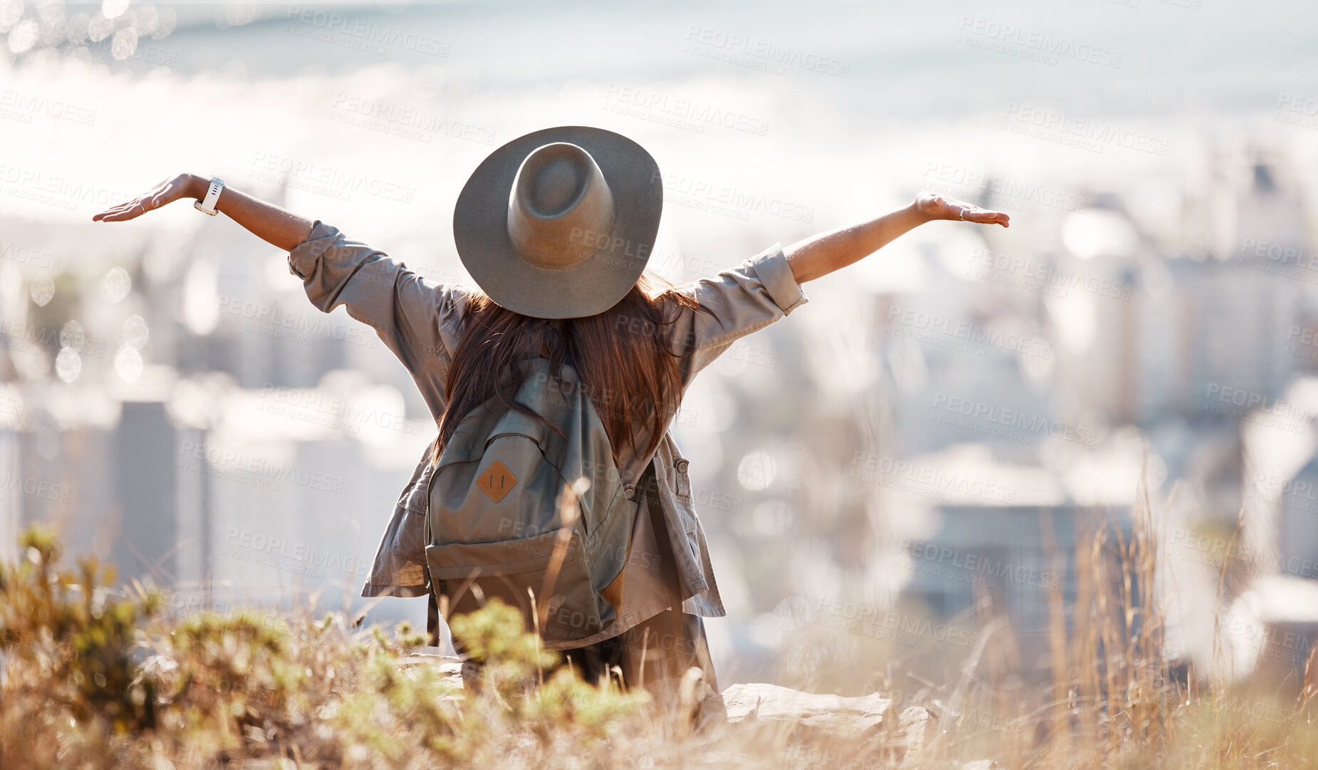 Buy stock photo Woman, tourist and hiking or travel freedom in city for adventure, backpacking or journey on mountain in nature. Female hiker with open arms enjoying fresh air, trekking or scenery of an urban town