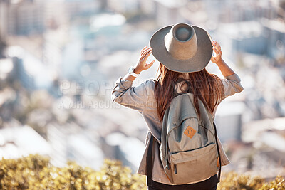 Buy stock photo Woman back, mountain and cityscape view for hiking, travel and nature for holiday, summer and wellness goal. Girl, explorer and mountains with city skyline, buildings and looking in morning sunshine