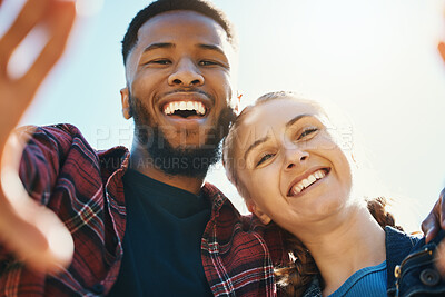 Buy stock photo Interracial love, couple selfie and laughing at funny joke outdoors, having fun or bonding in low angle. Comic smile, romance portrait and black man and woman take pictures for happy memory together